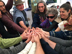 People circling joining hands